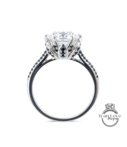 A close-up view of a silver engagement ring with a large central diamond surrounded by smaller diamonds and a floral-inspired design.