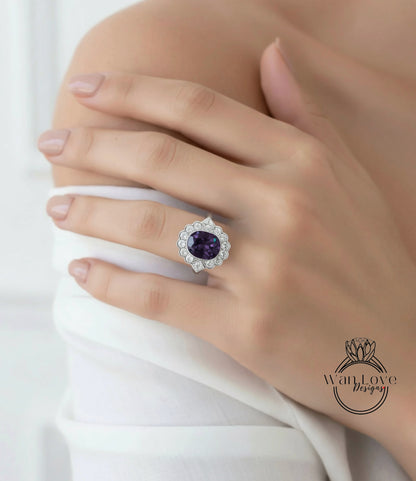 A close-up of a person's hand wearing a large, ornate ring with a purple gemstone.