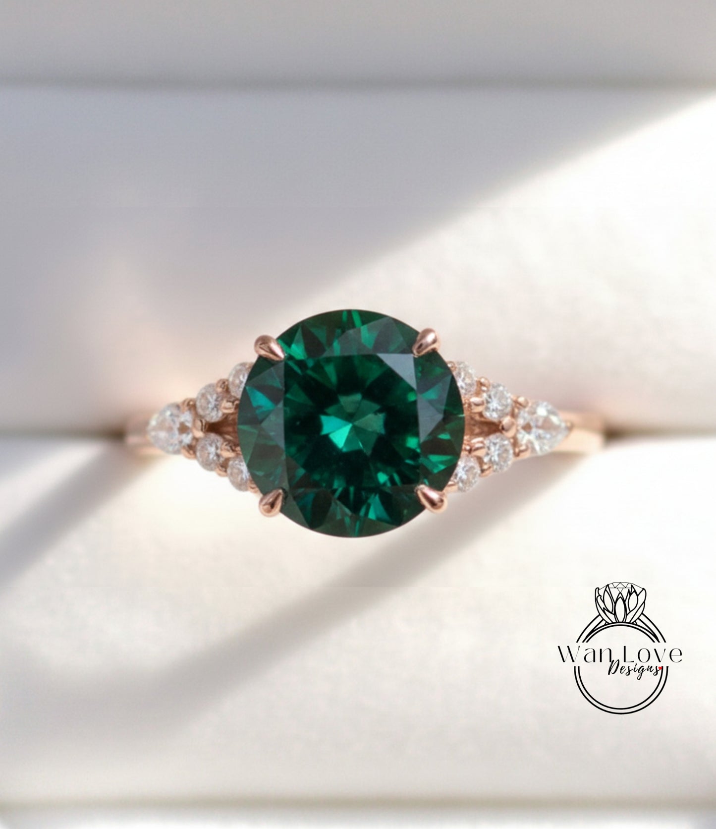 A close-up view of a gold ring with a large, dark green gemstone at the center, surrounded by smaller diamonds.