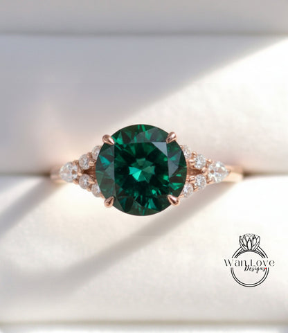 A close-up view of a gold ring with a large, dark green gemstone at the center, surrounded by smaller diamonds.