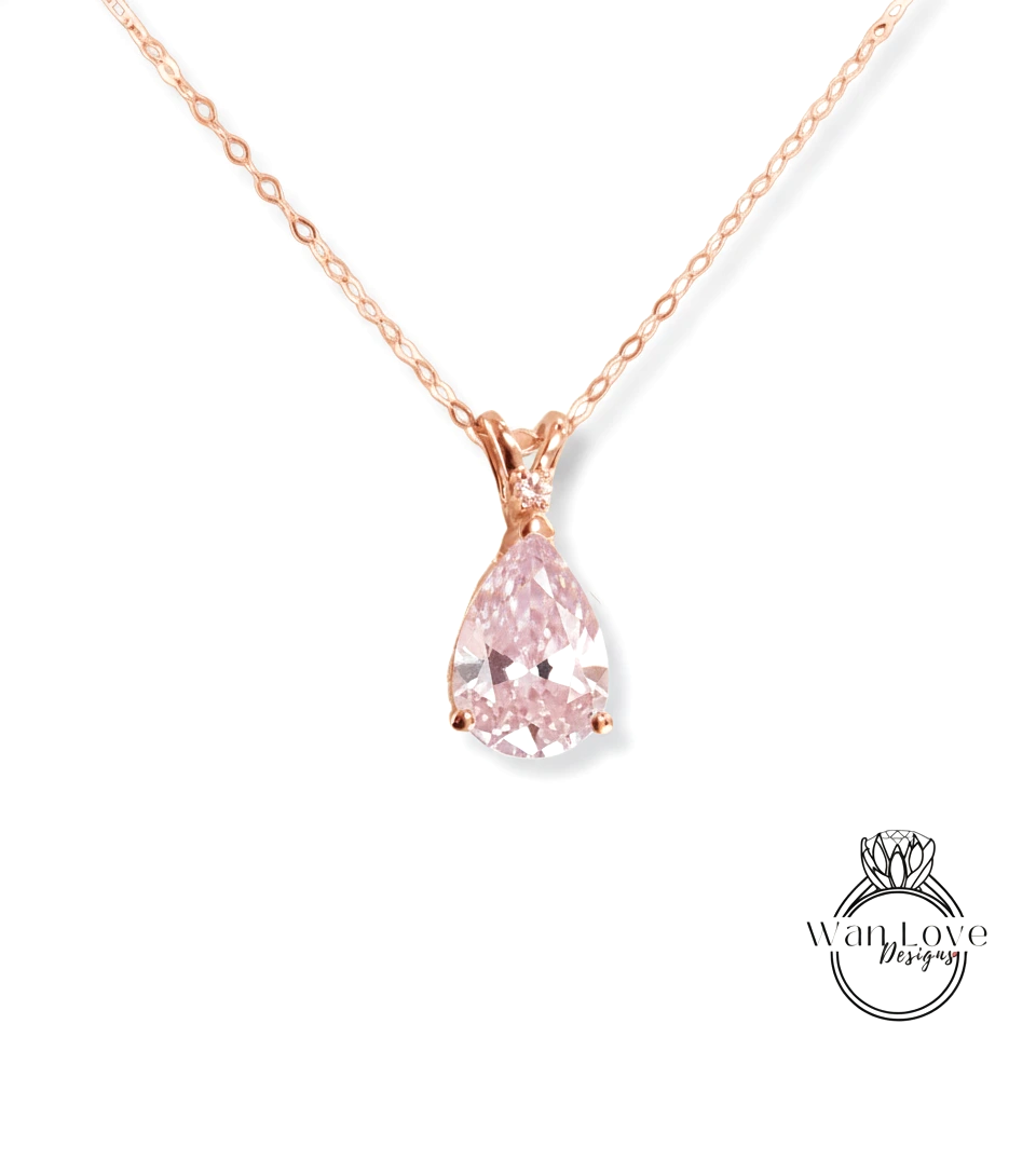 A delicate rose gold necklace with a single, large, clear pink diamond pendant.