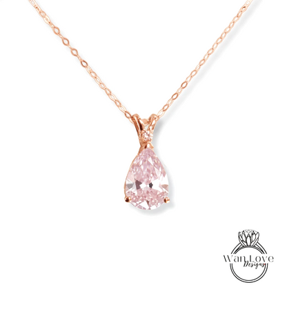 A delicate rose gold necklace with a single, large, clear pink diamond pendant.