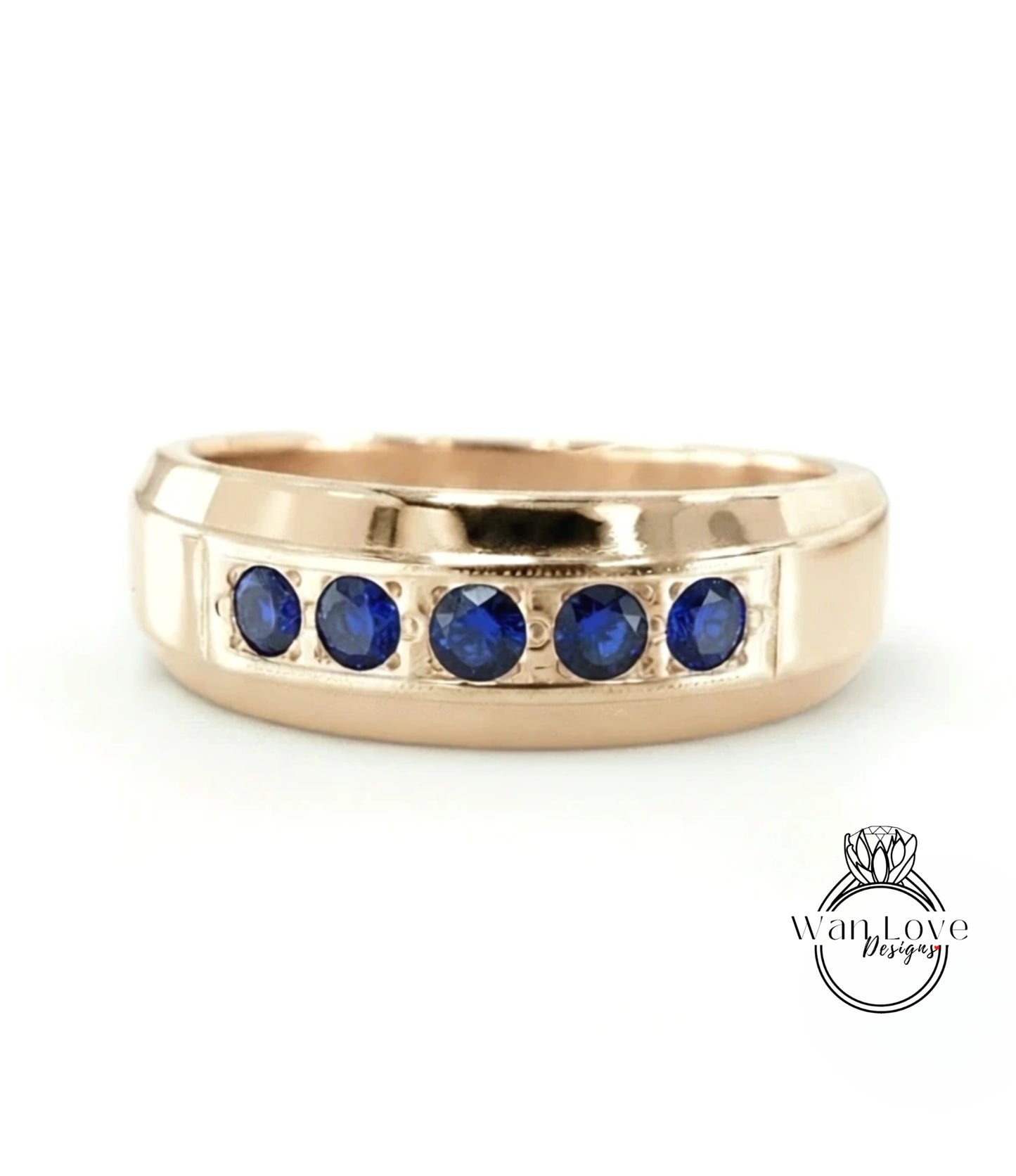 A gold ring with a row of blue sapphires set in the band.