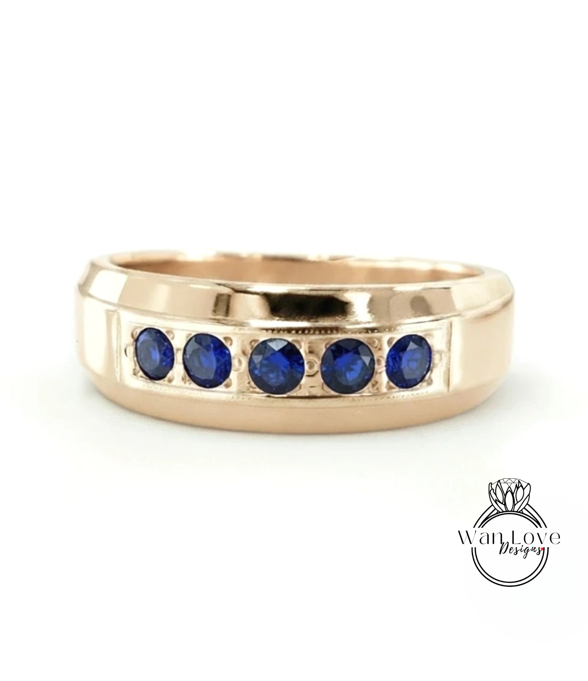 A gold ring with a row of blue sapphires set in the band.