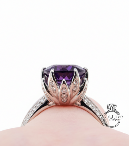 A close-up view of a silver ring with a large purple gemstone, showcasing the intricate design and craftsmanship.