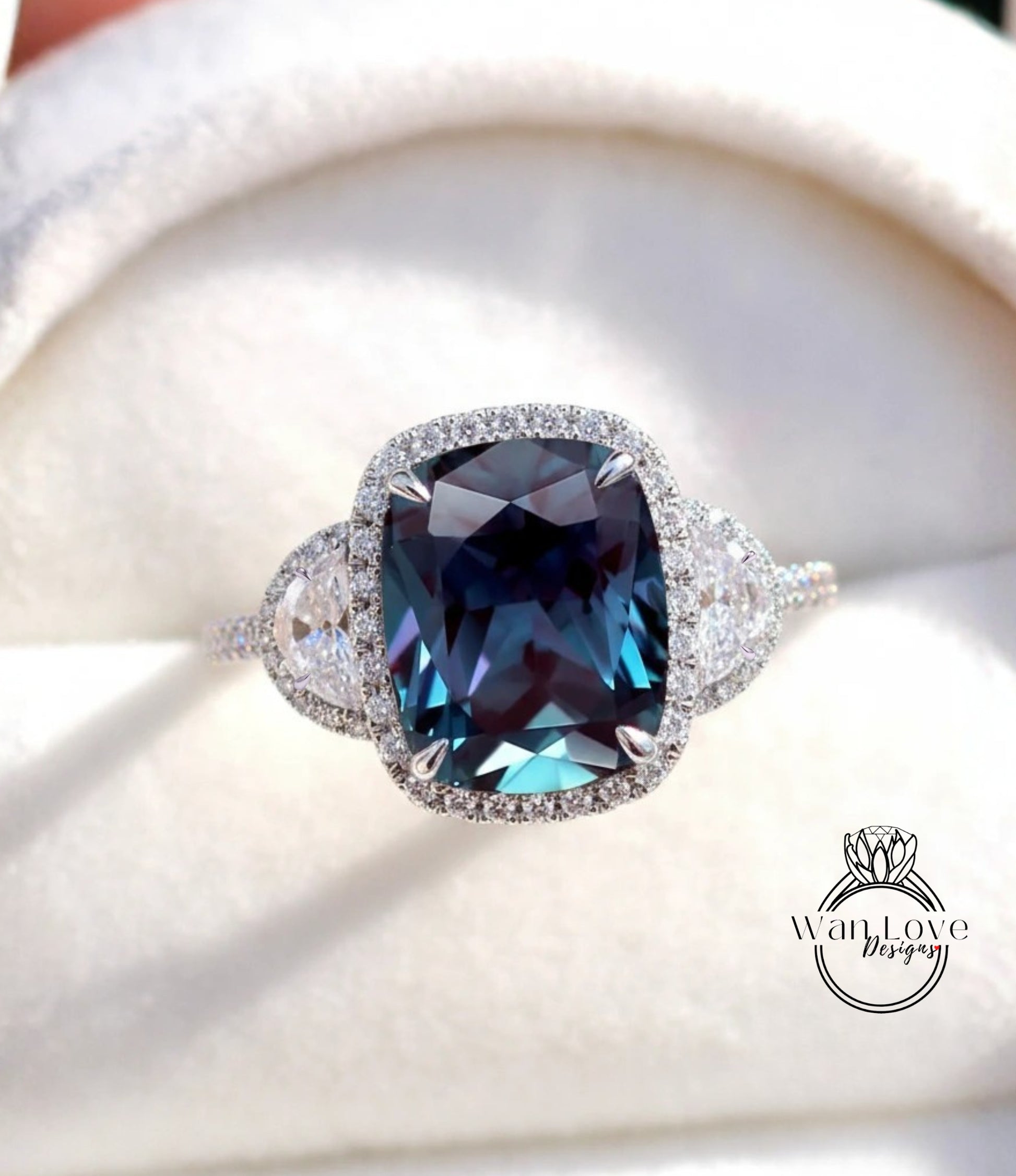 A close-up image of a diamond ring with a large blue gemstone set in a halo of smaller diamonds.