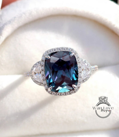 A close-up image of a diamond ring with a large blue gemstone set in a halo of smaller diamonds.