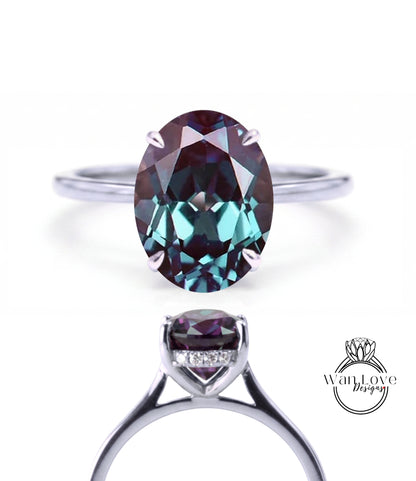 a silver ring with a large oval-shaped gemstone, which appears to be a deep blue sapphire.