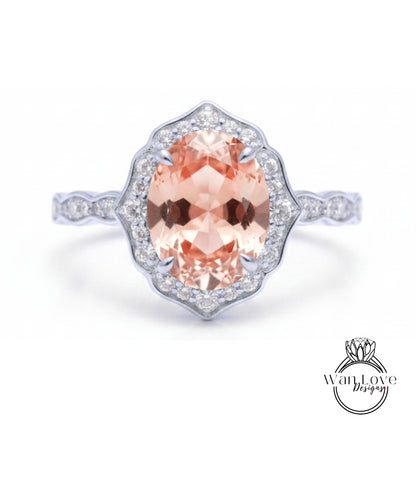 A beautiful engagement ring with a large oval-shaped gemstone surrounded by a halo of smaller diamonds set in a silver band.