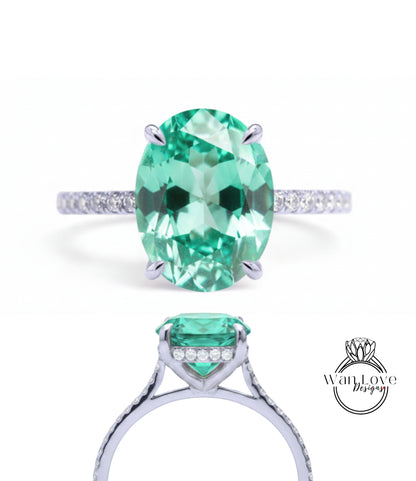A stunning engagement ring with a large oval-shaped gemstone set in a silver band, surrounded by smaller diamonds.