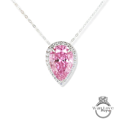 A necklace with a large, pink pear-shaped diamond set in a halo of smaller diamonds.