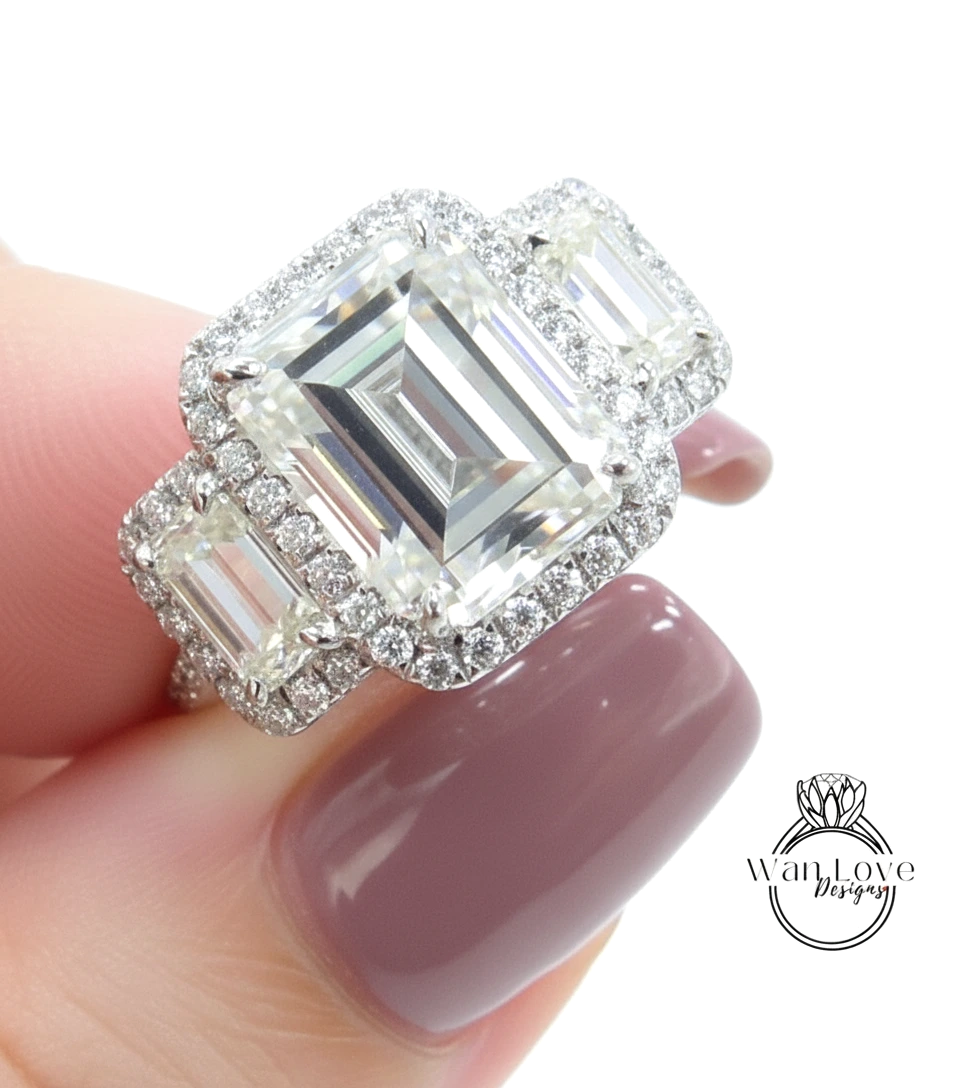 A close-up of a person's hand holding a large, ornate diamond ring with a halo of smaller diamonds around the main diamond.