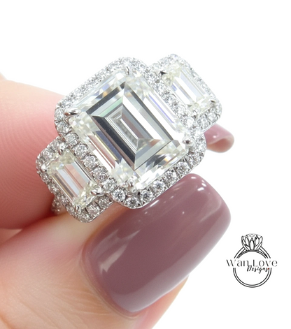 A close-up of a person's hand holding a large, ornate diamond ring with a halo of smaller diamonds around the main diamond.