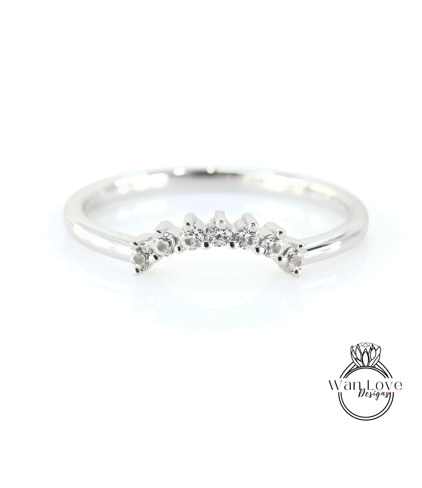 A silver ring with a row of small diamonds set in the center.
