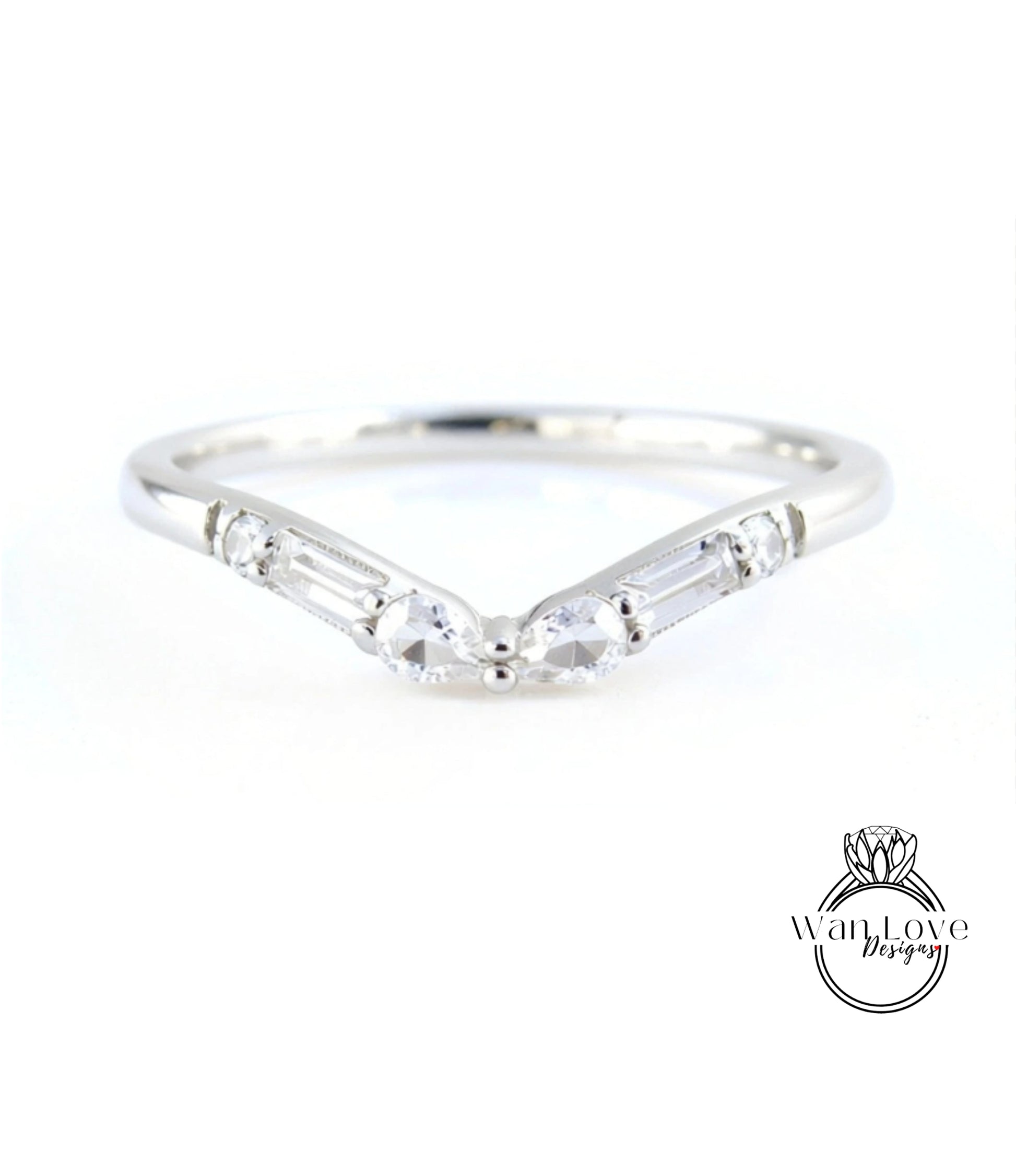 A silver ring with a v-shaped band and two large, clear gemstones.