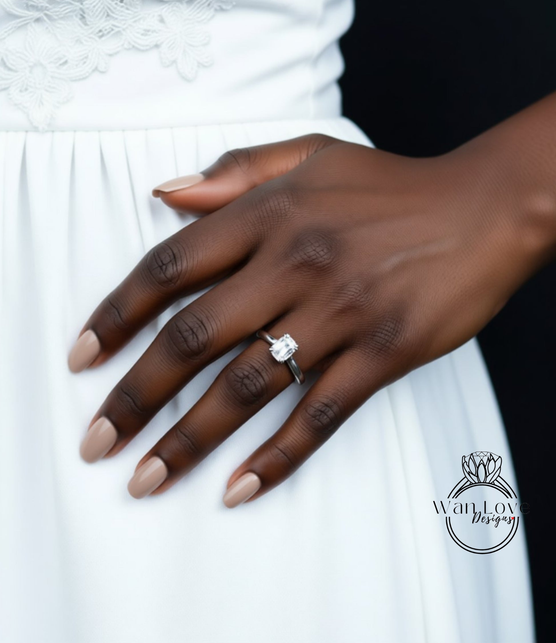 A close-up of a hand wearing a diamond engagement ring on the ring finger.