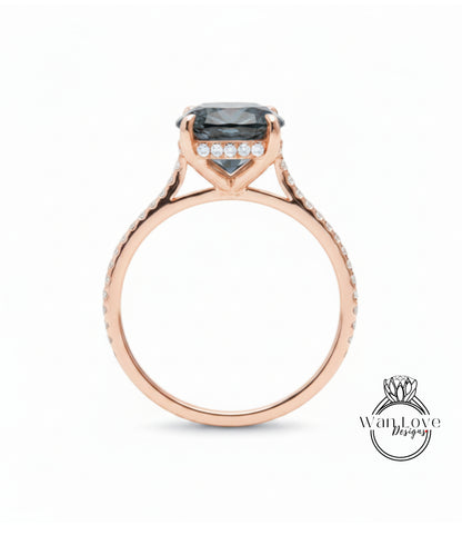 A rose gold engagement ring with a large blue gemstone set in the center, surrounded by smaller diamonds.