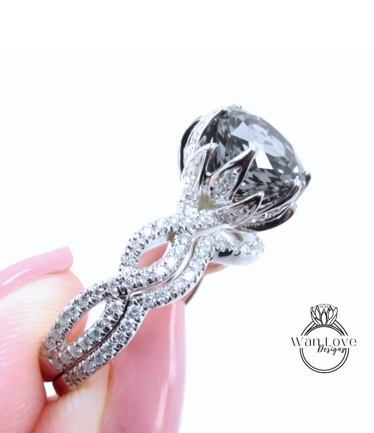 A close-up of a person's hand holding a large, ornate diamond engagement ring with a large central gemstone surrounded by smaller diamonds and a twisted metal band.