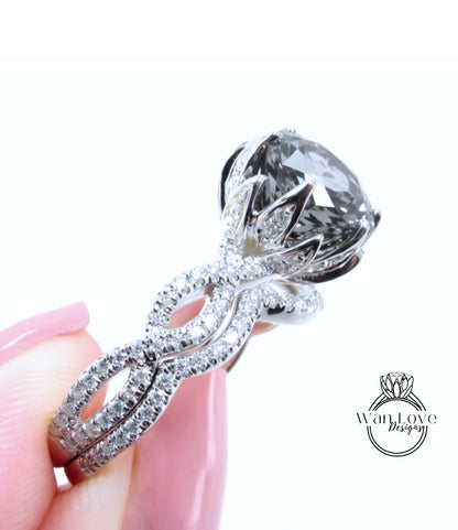 A close-up of a person's hand holding a large, ornate diamond engagement ring with a large central gemstone surrounded by smaller diamonds and a twisted metal band.