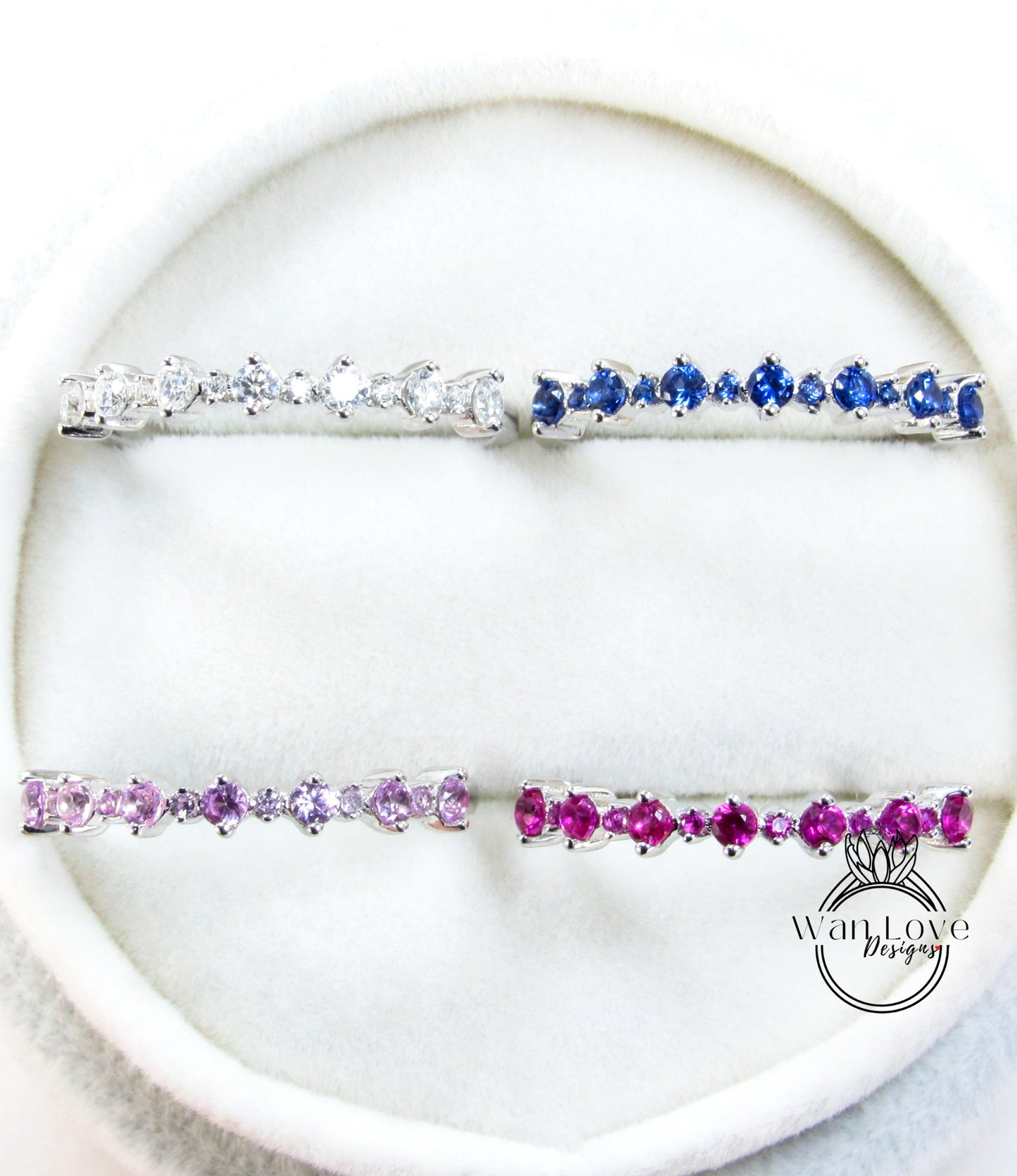 a collection of four silver and four pink gemstone bracelets arranged on a white surface.