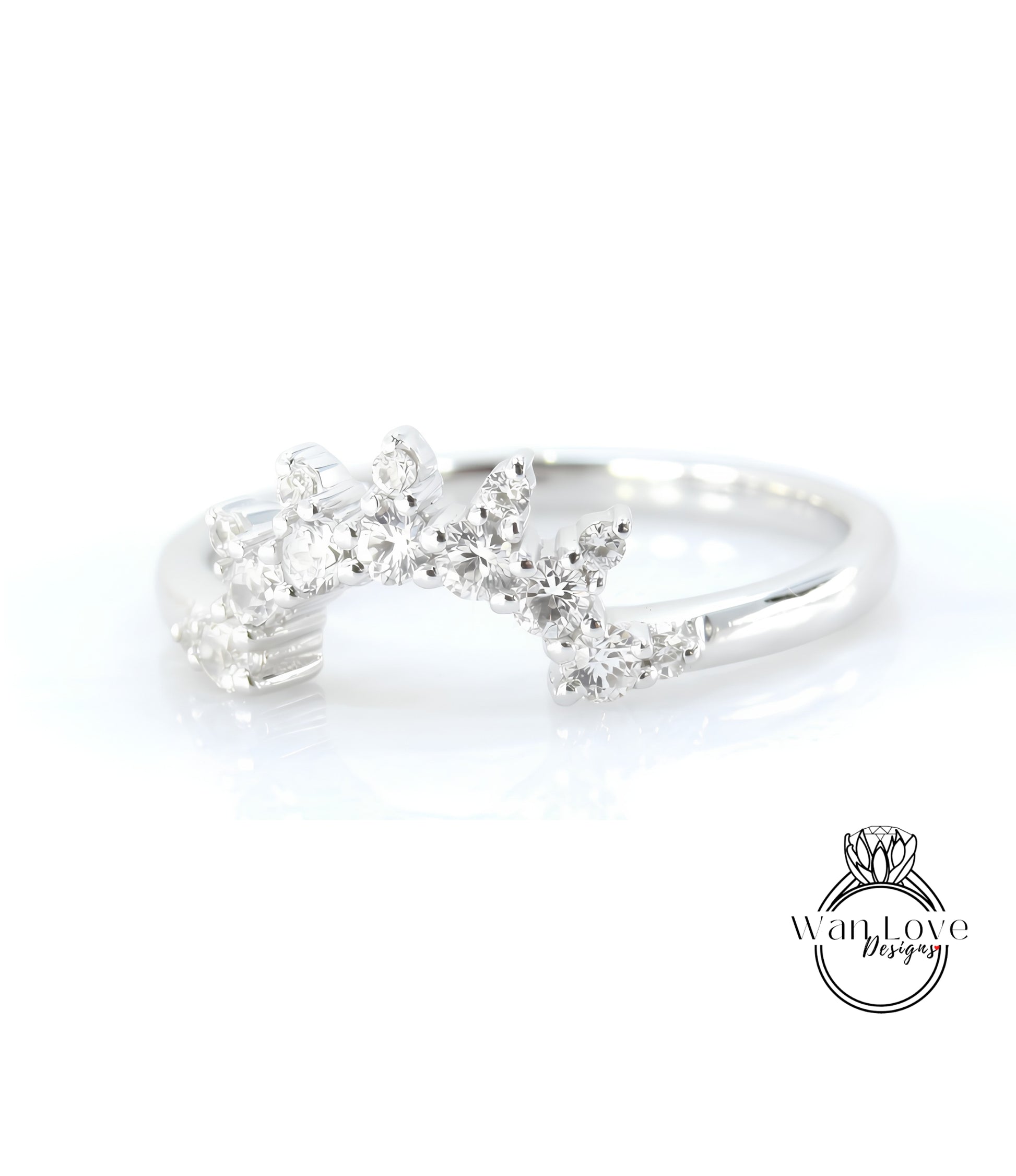 A silver ring with a decorative design featuring small diamonds or gemstones.