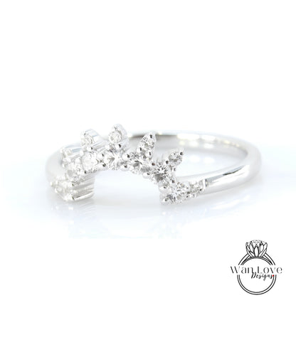 A silver ring with a decorative design featuring small diamonds or gemstones.