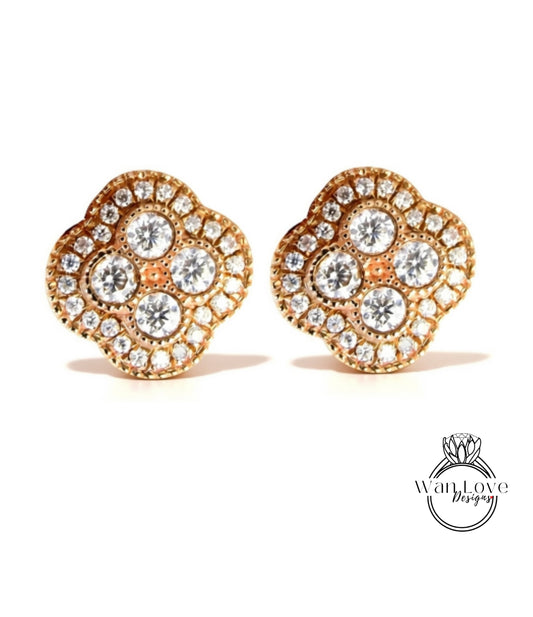 A pair of gold earrings with a diamond design, featuring multiple small diamonds arranged in a flower-like pattern.