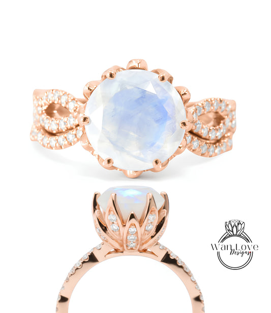 a beautiful rose gold ring with a large moonstone and a delicate flower-like design.