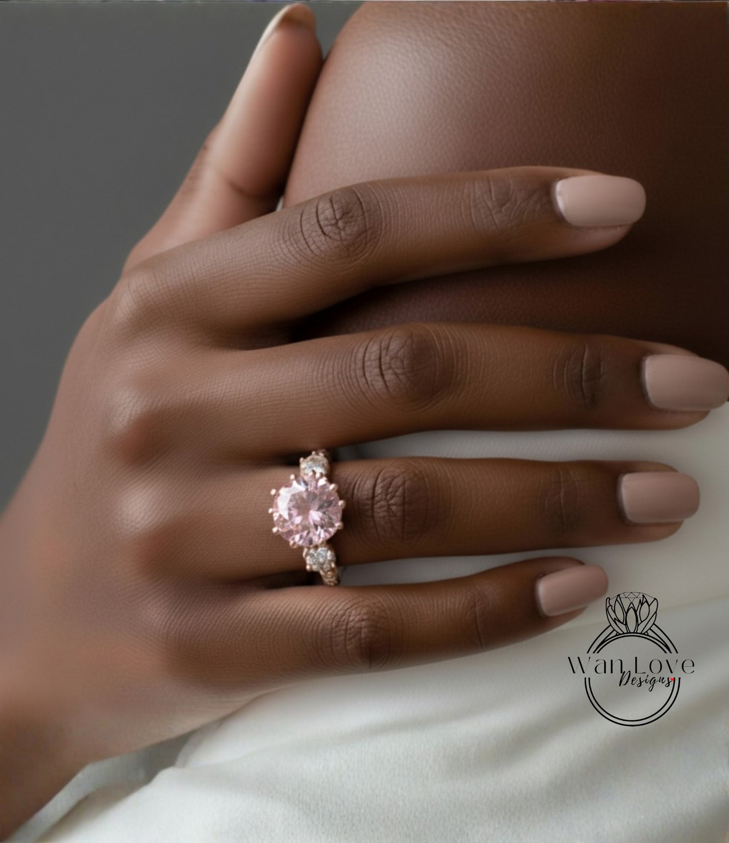 A close-up of a hand wearing a pink diamond engagement ring.