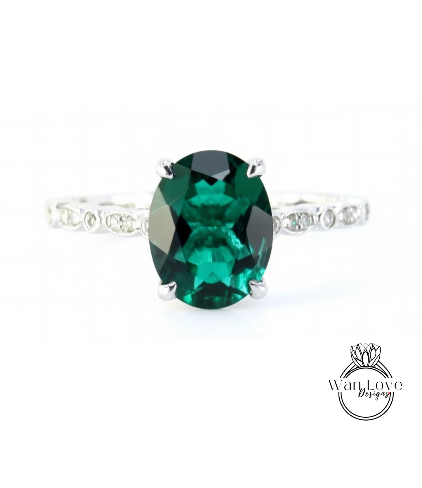 A close-up image of a ring featuring a large oval-shaped green gemstone, surrounded by smaller diamonds.