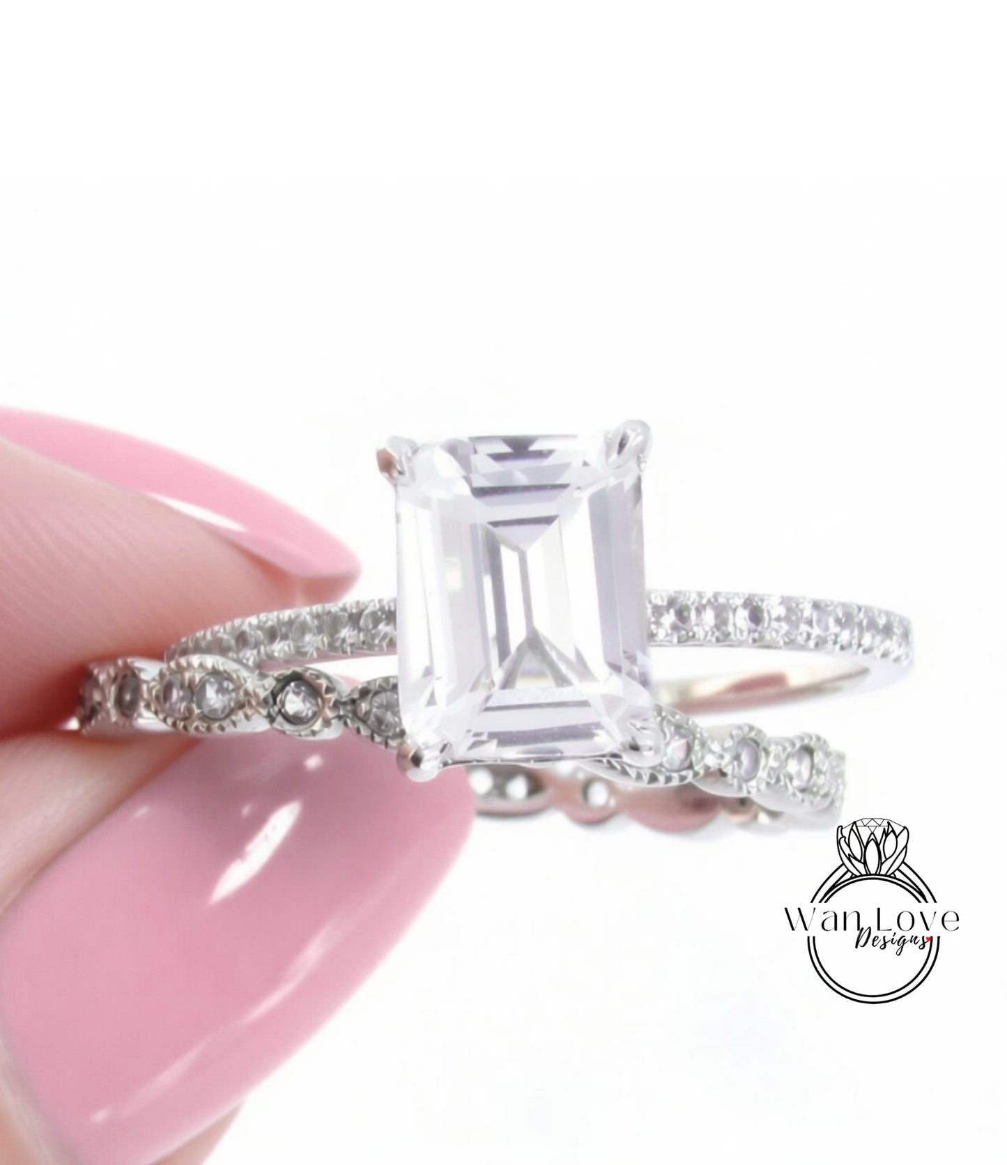 A close-up of a person's hand holding a diamond engagement ring, with the ring's centerpiece being a large, clear gemstone surrounded by smaller diamonds.