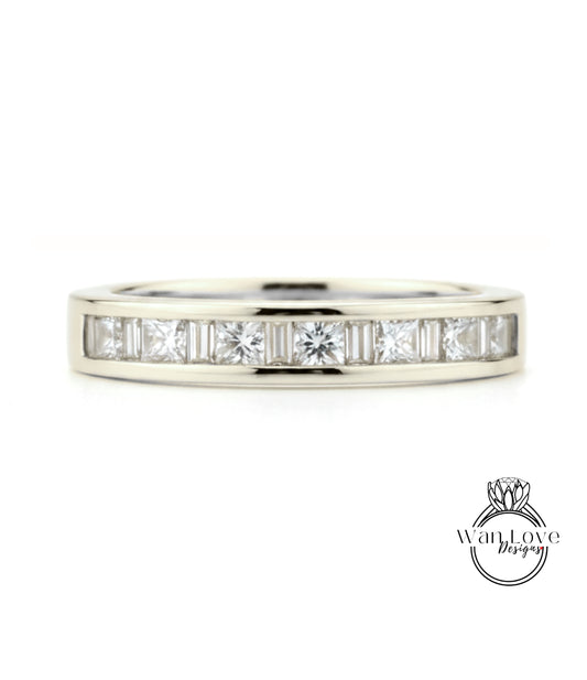 A silver band ring with a row of clear diamonds set in it.