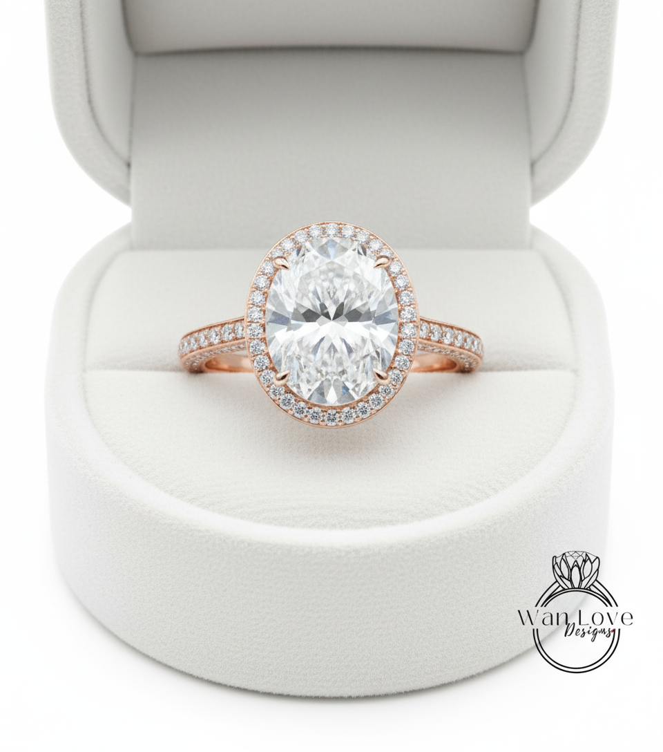 A large, round diamond engagement ring is displayed in a white jewelry box.