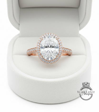 A large, round diamond engagement ring is displayed in a white jewelry box.