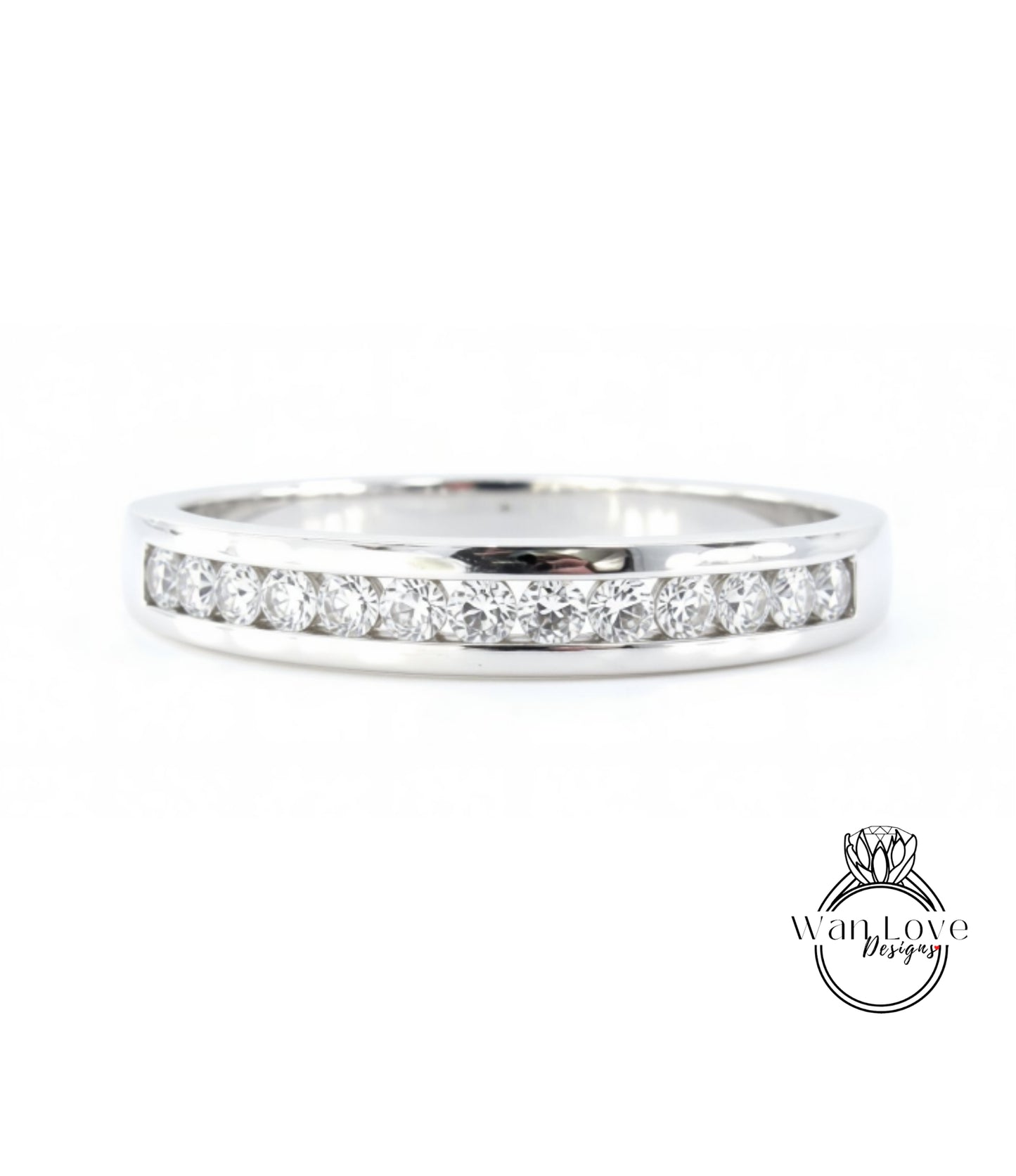 A silver ring with a row of diamonds set in it.