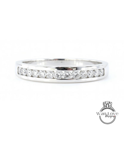 A silver ring with a row of diamonds set in it.