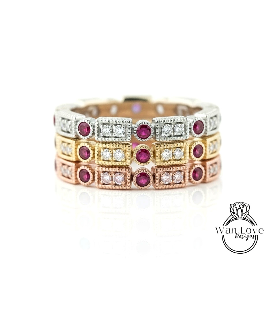 A ring with multiple layers of rings, each ring featuring a gemstone, such as a diamond and a red gemstone. The rings are arranged in a layered design, creating a visually appealing and intricate piece of jewelry.