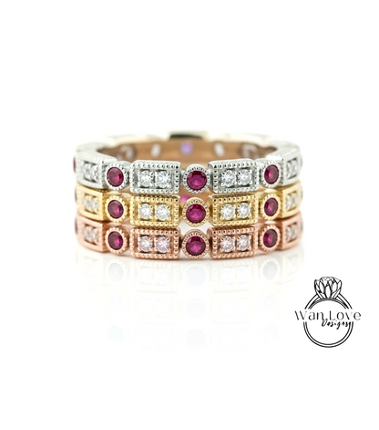 A ring with multiple layers of rings, each ring featuring a gemstone, such as a diamond and a red gemstone. The rings are arranged in a layered design, creating a visually appealing and intricate piece of jewelry.