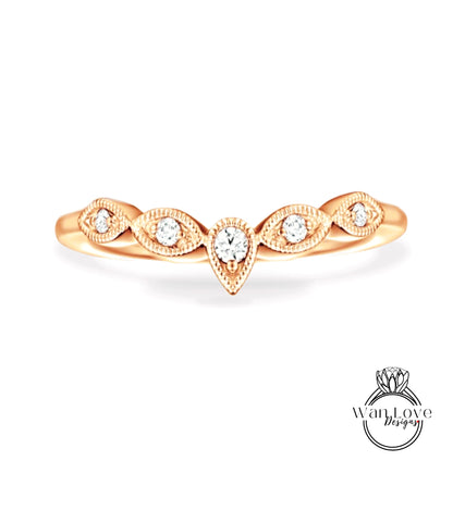 A gold ring with a central diamond surrounded by smaller diamonds, showcasing intricate detailing and a delicate design.