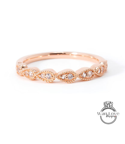 A rose gold ring with a row of small diamonds set in the center.