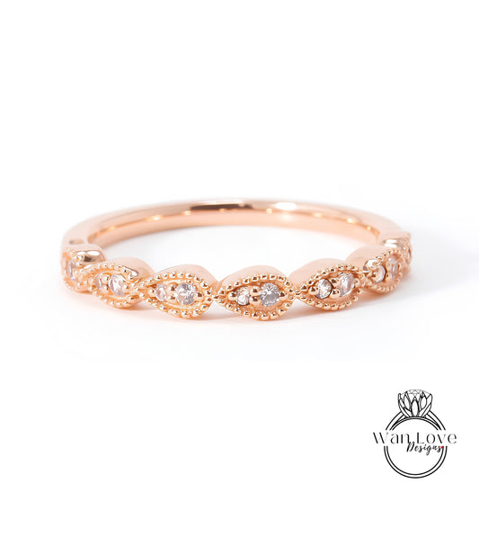 A rose gold ring with a row of small diamonds set in the center.