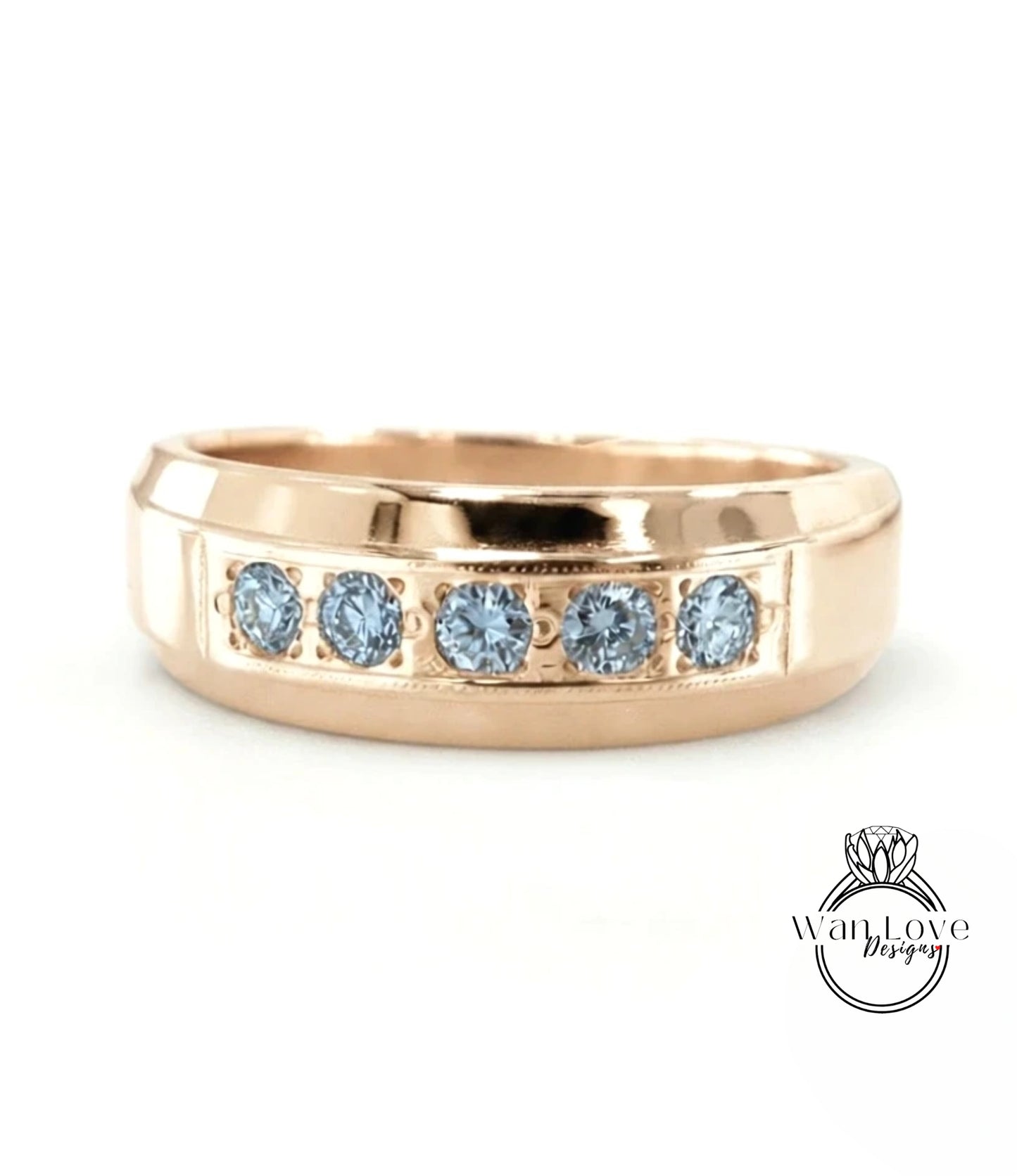 A gold ring with a row of blue diamonds set in the band.