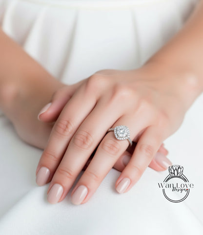 A close-up of a person's hand wearing a diamond engagement ring.