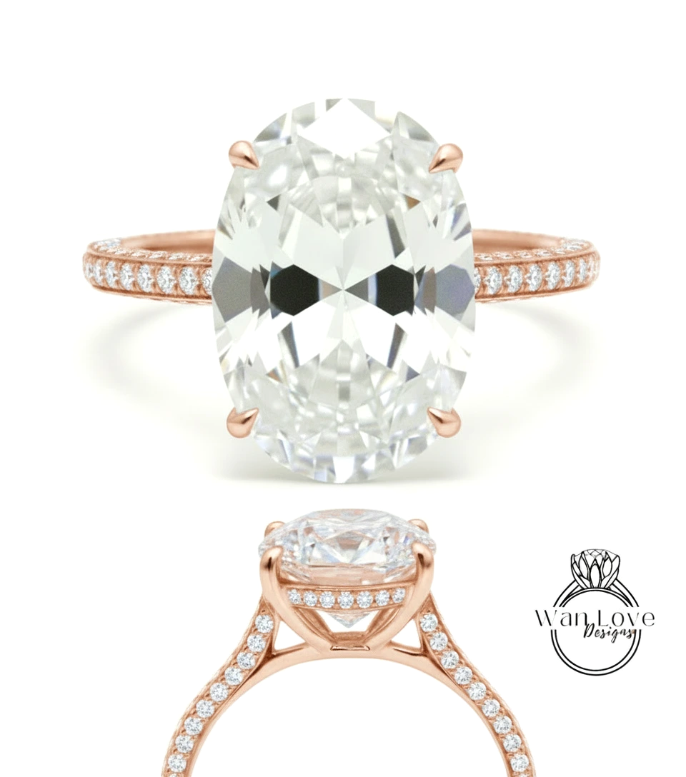 a large, oval-shaped diamond engagement ring with a rose gold band and a row of small diamonds along the band.