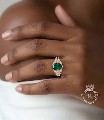 A close-up of a person's hand wearing a ring with a large, green gemstone surrounded by smaller stones.