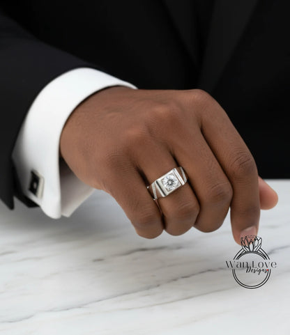A close-up of a person's hand wearing a silver ring on the ring finger.