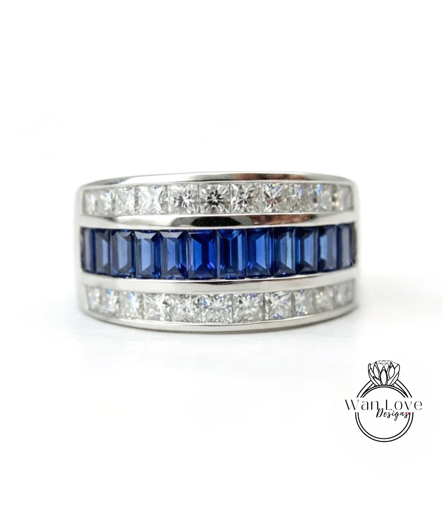 A silver ring with a row of blue gemstones, including sapphires and diamonds, set in a band.