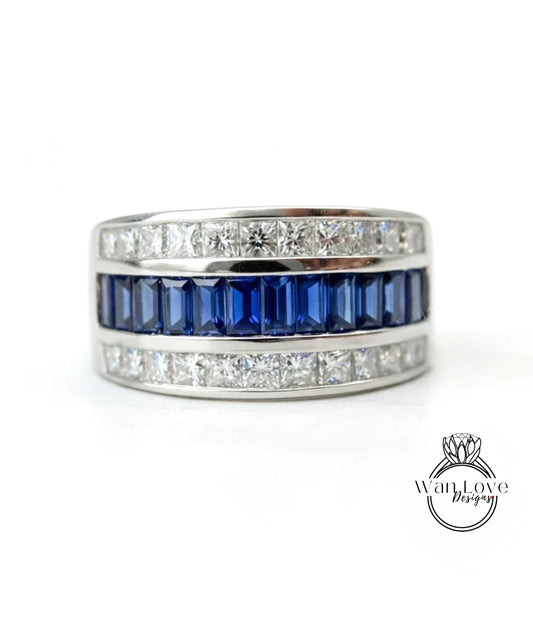 A silver ring with a row of blue gemstones, including sapphires and diamonds, set in a band.