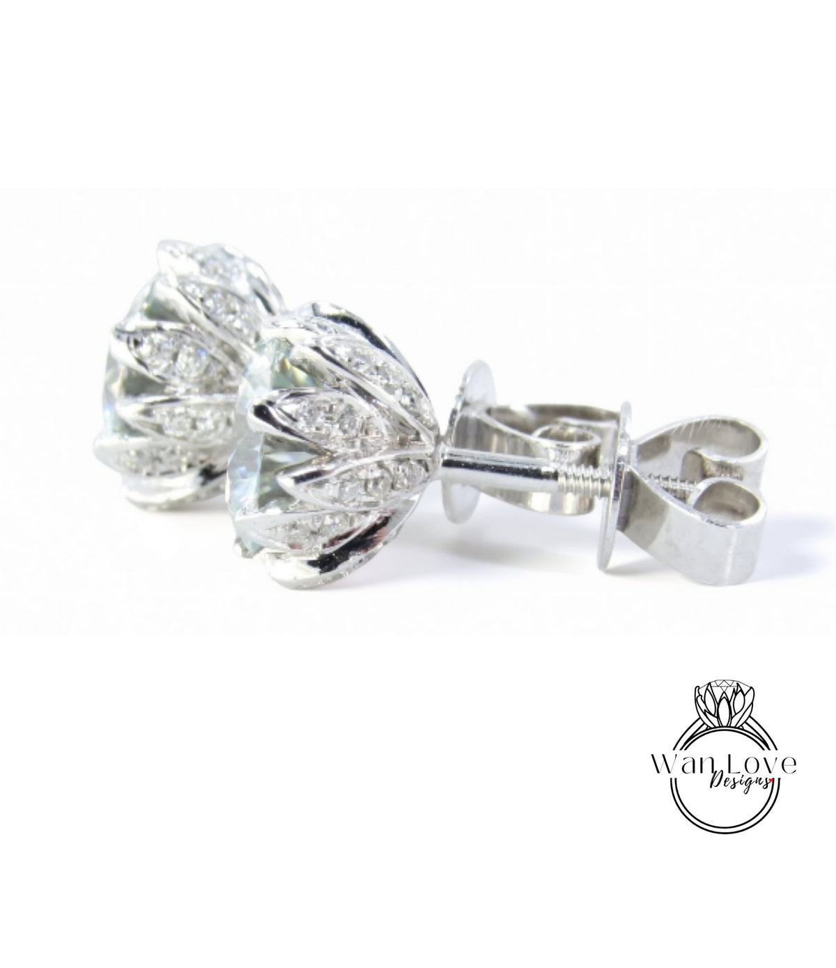 A pair of elegant silver earrings with a floral design and sparkling gemstones.