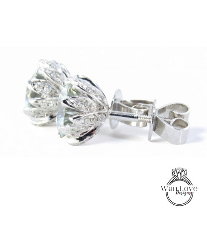 A pair of elegant silver earrings with a floral design and sparkling gemstones.
